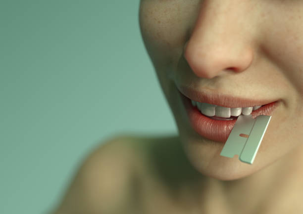 woman gently biting razor blade - cutting cocaine imagens e fotografias de stock