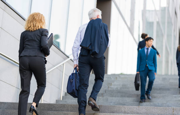 istock Business People Walking On Stairs 1142271082
