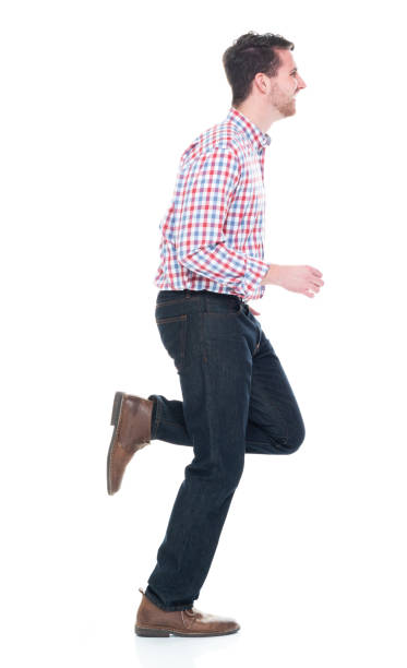 istock Handsome man wearing checked shirt and jeans - running 1142271205