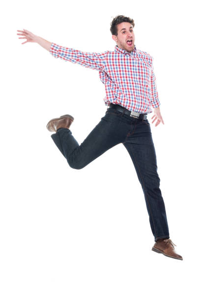 istock Handsome man wearing checked shirt and jeans - running and jumping 1142271255