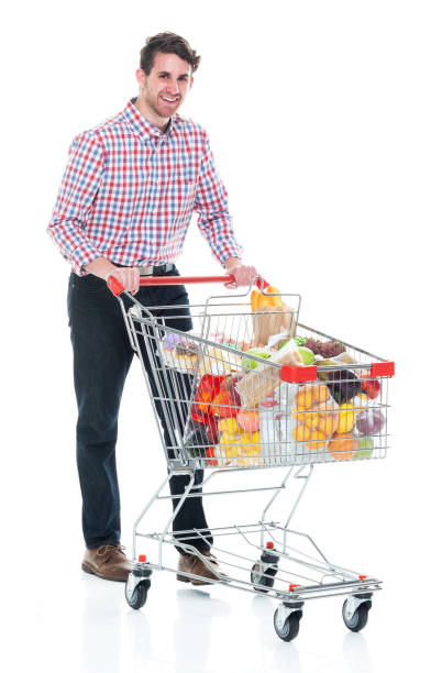istock Handsome man pushing a shopping cart with food inside - walking 1142271533