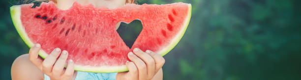 un bambino mangia anguria. messa a fuoco selettiva. cibo. - picnic watermelon summer food foto e immagini stock