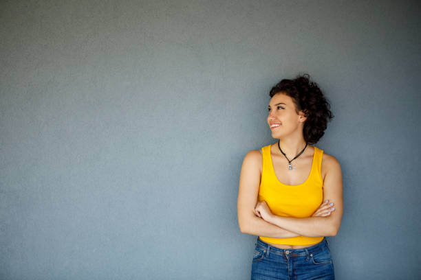 istock Cute young woman posing against a gray background 1142273777