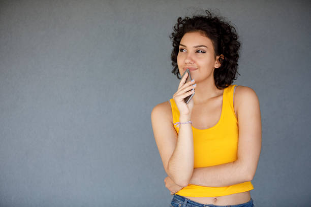 istock Thoughtful woman holding her cell phone 1142274002