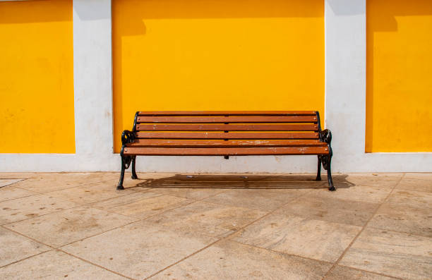 istock seats against yello wall in Pondicherry, India 1142276718