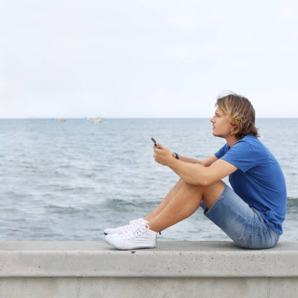 istock Teenage boy typing text message.Using smart phone. 1142278192