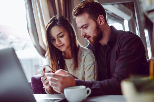istock Male Showing New Technology In Smartphone To Girlfriend 1142284933