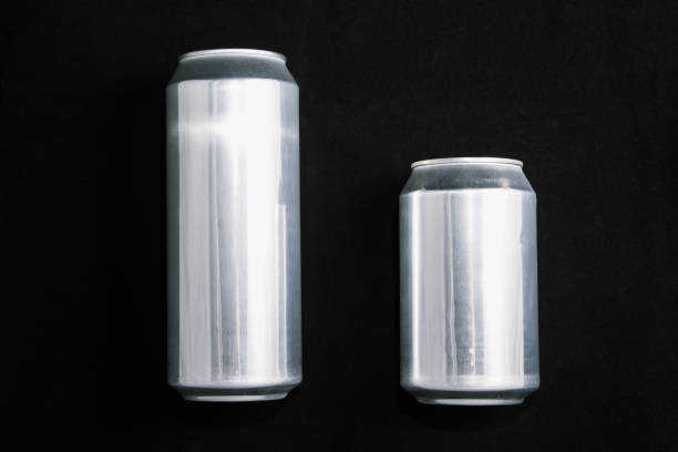Big 0.5 and small 0.33 aluminium cans on black background. stock photo