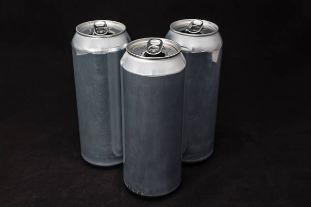 istock 3 aluminium cans. Scratched, on black background. Simple minimalism 1142288771