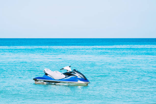 blue hydrocycle scooter in the water near the beach. no people - wake jet boat water water sport imagens e fotografias de stock