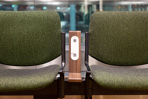 Green chairs with  free standard USB power socket or USB port slot charger in airport. Travelling comfort