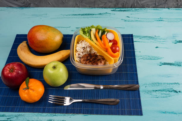 istock Lunch box with appetizing food and on light wooden table. Copy space. 1142292187
