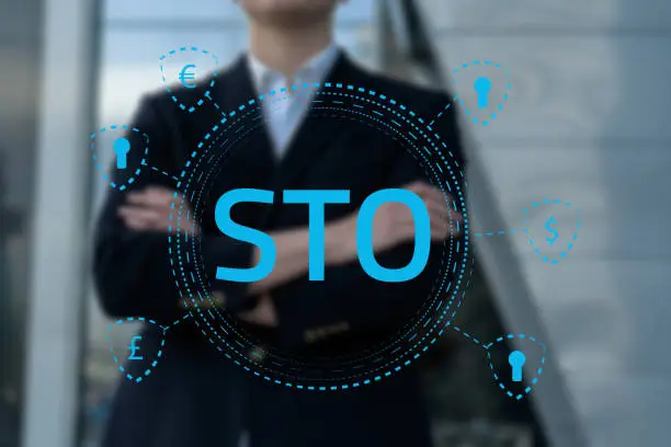 Photo of Security Token Offering STO cryptocurrency and blockchain concept, businessman pressing virtual graphics on virtual screens