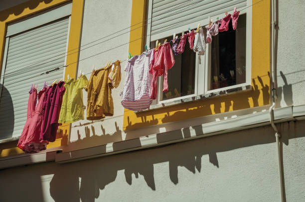 istock Clothes hanging on window drying in a colorful house 1142299869