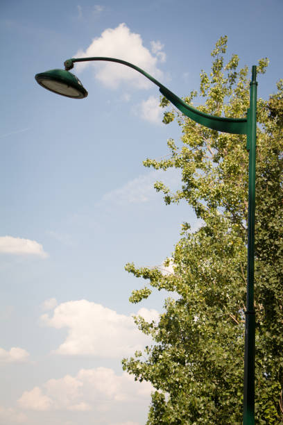 istock Lanterns in the park against the sky and trees. Blue sky with white clouds 1142300686