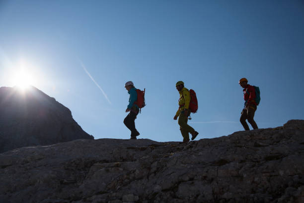 istock Group of mountaineers walking on the edge 1142303417