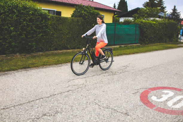 istock Woman riding on her electric bicycle 1142309201