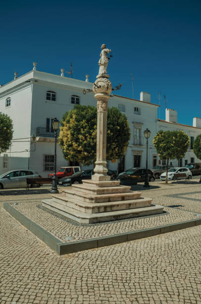 istock Marble pillory in deserted square with old buildings 1142312903