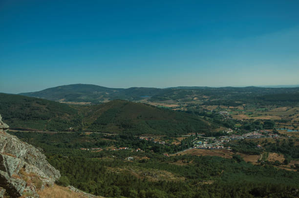 istock Mountainous landscape covered by trees and cultivated fields 1142314798