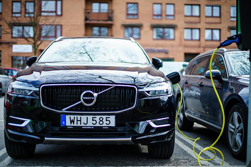 Gothenburg, Sweden - April 6, 2019: Volvo S90 and VW Passat new generation Hybrid electric Vehicle charging on the Goteborg Street Car Park
