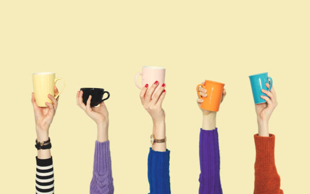 istock Many different arms raised up holding coffee cup 1142319768