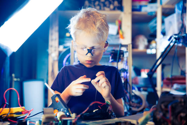 istock Boy and hot glue gun 1142322714