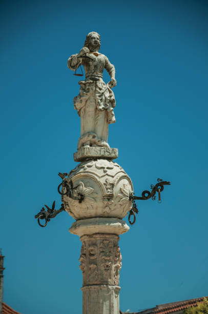 istock Marble sculpture representing justice on top of carved pillory 1142324393