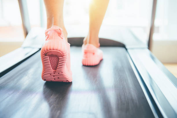 istock Fitness girl running on treadmill 1142333151