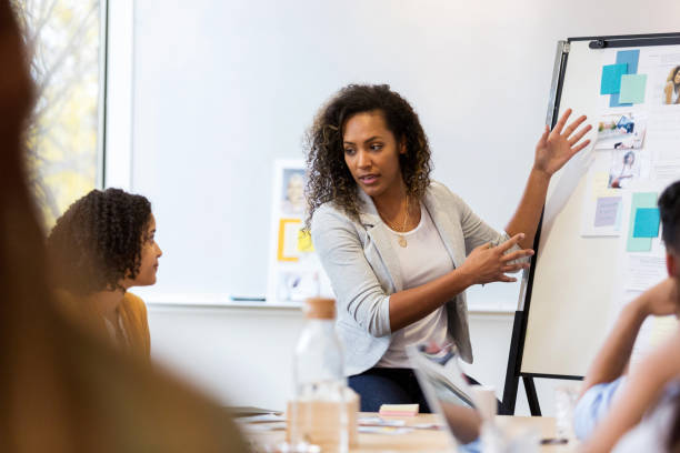 istock Creative professional shares ideas with coworkers 1142334353