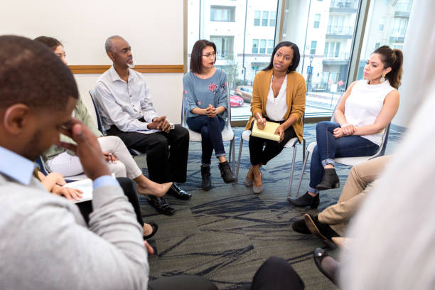 istock Counselor gives advice during group therapy 1142334487