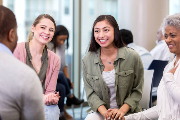 istock Women laugh together during group therapy session 1142334493