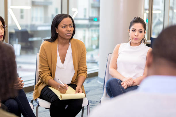 istock Counselor listens to client during group therapy 1142334497