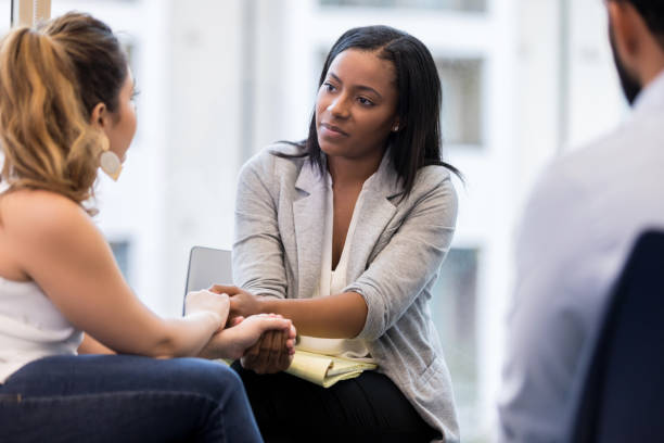 istock Young marriage counselor comforts couple 1142334514