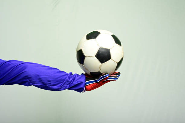 istock Soccer goalkeeper holding soccer ball 1142337228