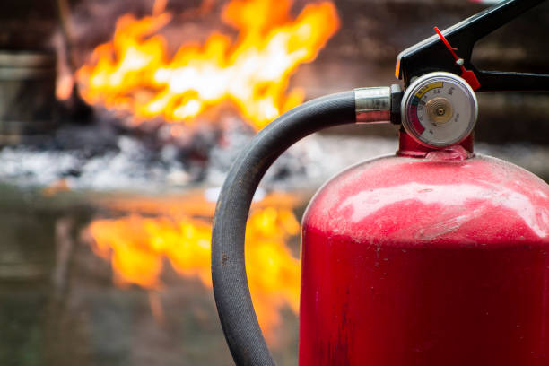 Burning Flames and Fire Extinguishers Burning Flames and Fire Extinguishers fire extinguisher photos stock pictures, royalty-free photos & images