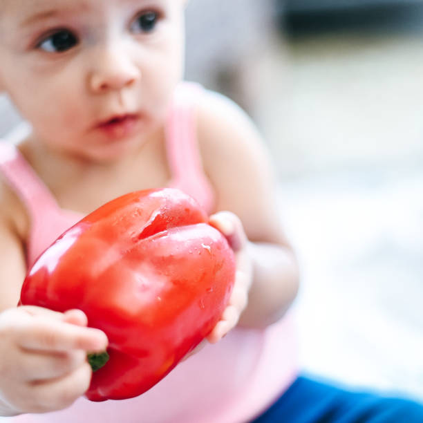 istock Baby and peppers 1142345653
