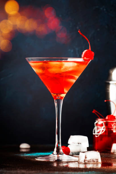 istock Classic alcoholic cocktail Manhattan with bourbon, red vemuth, bitter, ice and cocktail cherry in glass, gray bar counter background, place for text, selective focus 1142351218