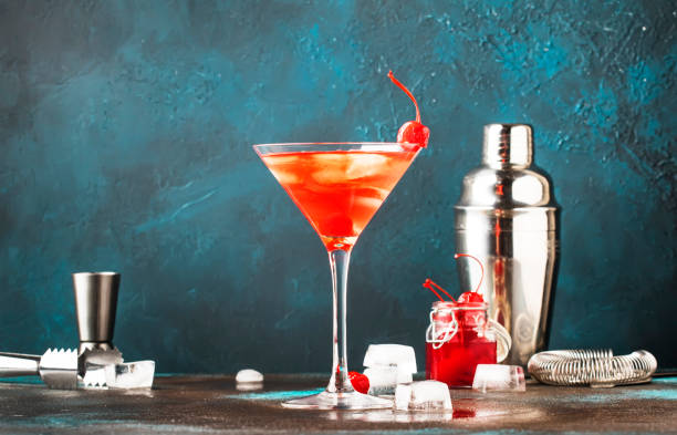 istock Classic alcoholic cocktail Manhattan with bourbon, red vemuth, bitter, ice and cocktail cherry in glass, gray bar counter background, place for text, selective focus 1142351257