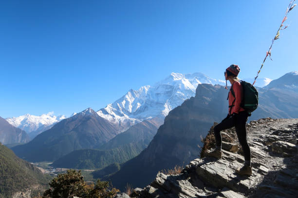 Women standing with a backpack Women standing with a backpack, Nepal annapurna circuit photos stock pictures, royalty-free photos & images