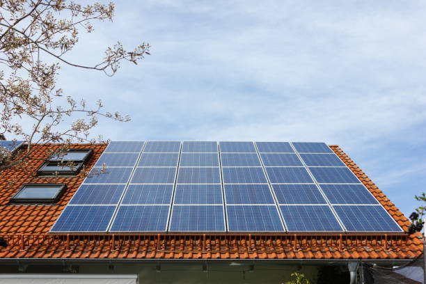 house with solar panels on rooftop stock photo