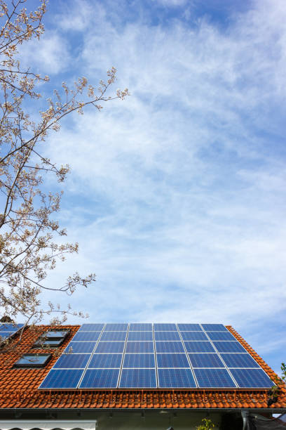 house with solar panels on rooftop stock photo