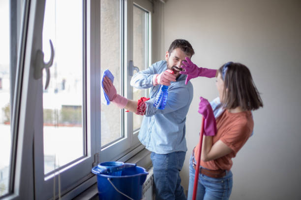 istock Beautiful young married couple cleaning apartment 1142357166