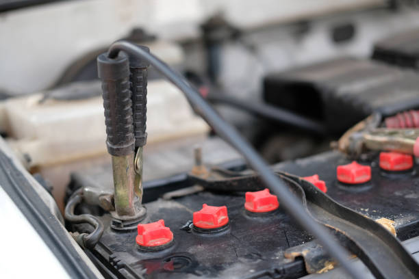 istock mechanic use jumper cables to charge dead car battery 1142357988