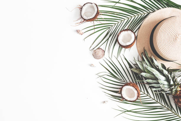 istock Summer composition. Tropical palm leaves, hat, coconut, pineapple on white background. Summer concept. Flat lay, top view, copy space 1142358967