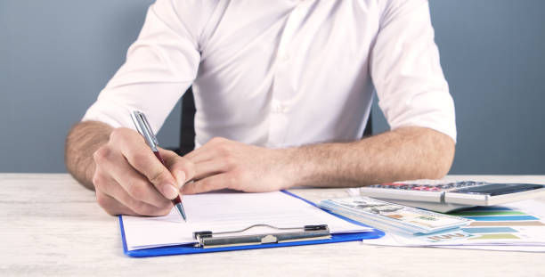 istock businessman calculator and tax 1142359247