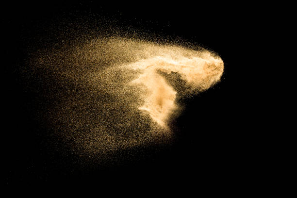 istock Sand explosion isolated on black background. Freeze motion of sandy dust splashing. 1142359261