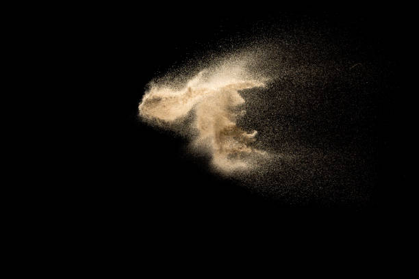 istock Sand explosion isolated on black background. Freeze motion of sandy dust splashing. 1142359266
