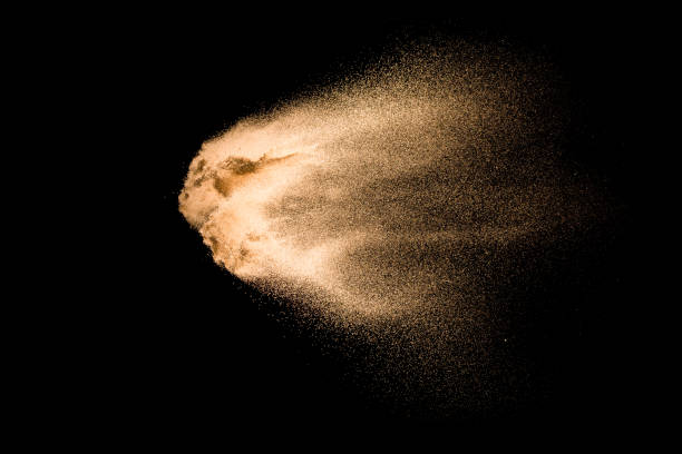istock Sand explosion isolated on black background. Freeze motion of sandy dust splashing. 1142359267