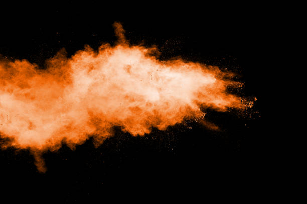istock Orange color powder explosion on black background. 1142359269