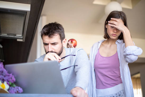 istock Focused  couple paying bills online on laptop 1142361311